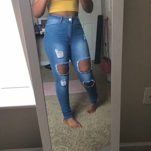 Distressed blue jeans by fashion nova